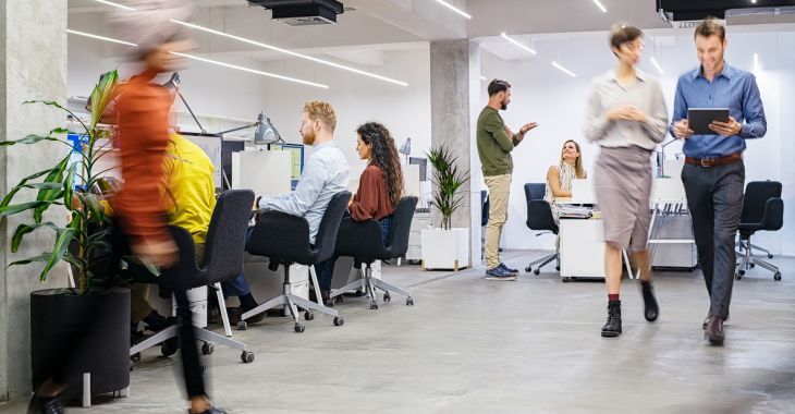 Busy open-space office with staff working together.