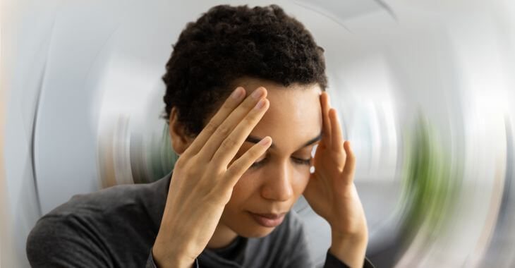 A woman experiencing dizziness due to sinus infection