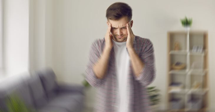 A man with headache caused by sinus infection experiencing dizziness 