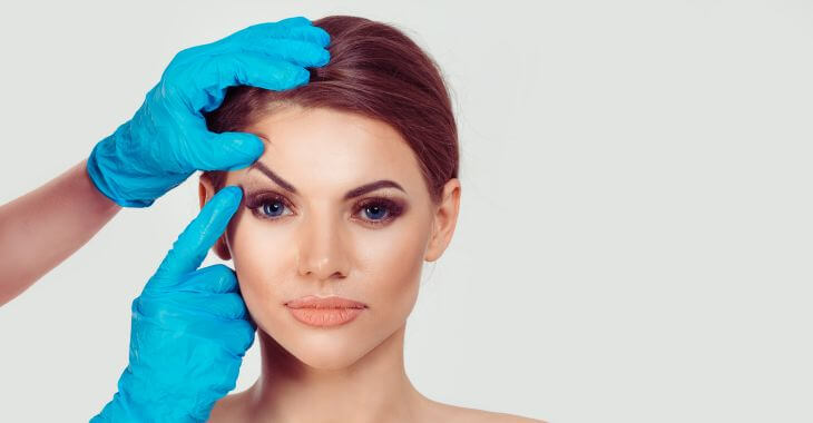 A plastic surgeon consulting a woman for eyes enlargement cosmetic surgery