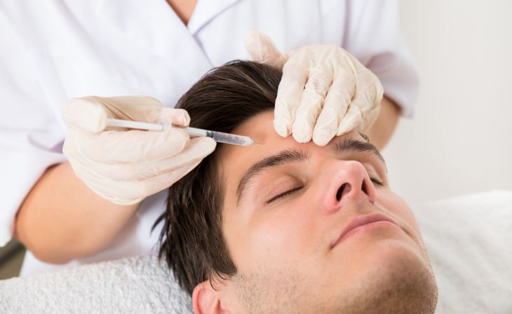 Man Having Forehead Botox  Treatment At Aesthetic Clinic