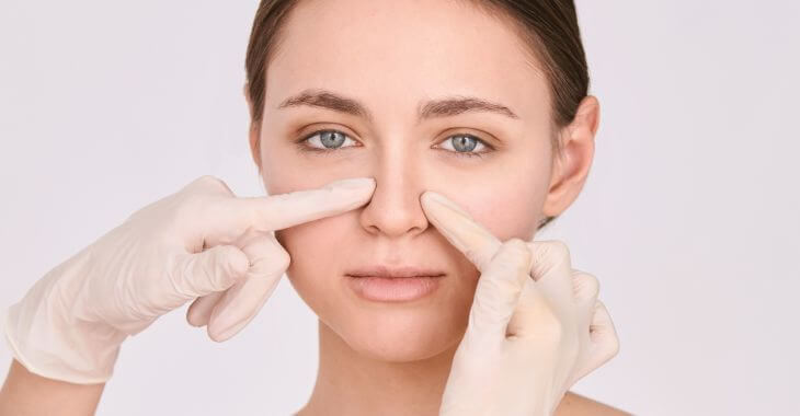 Plastic surgeon and a young woman during nose job consultation 